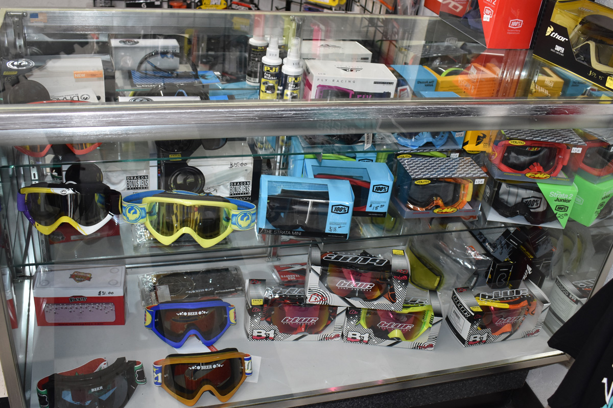 MX and Snowmobile Goggle display case in Xtreme Heights Motorsports showroom.